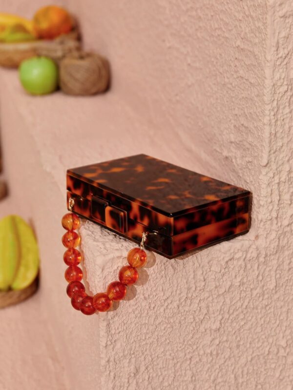 sama acrylic beaded clutch in amber 3